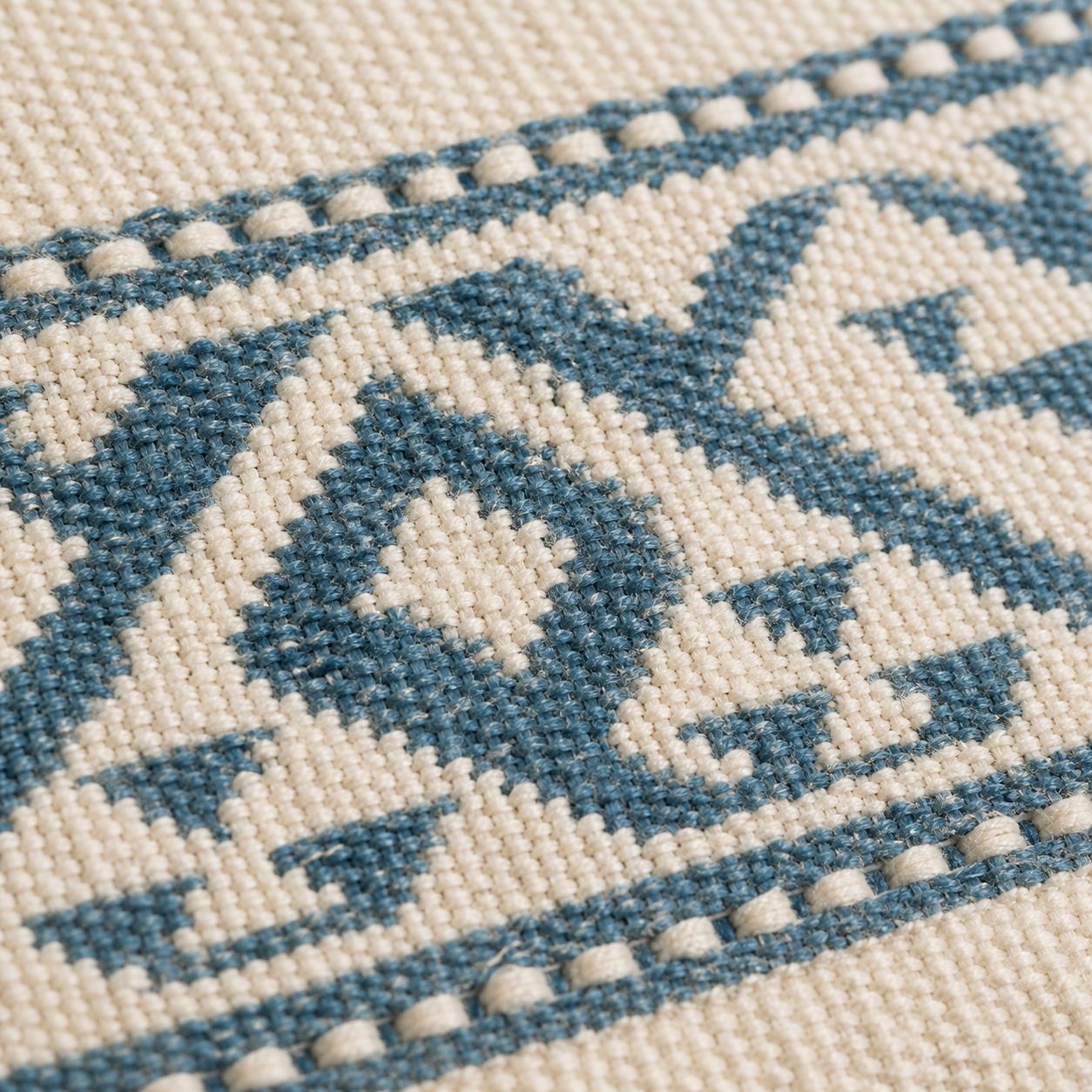 Macro of woven jacquard border with geometric motif